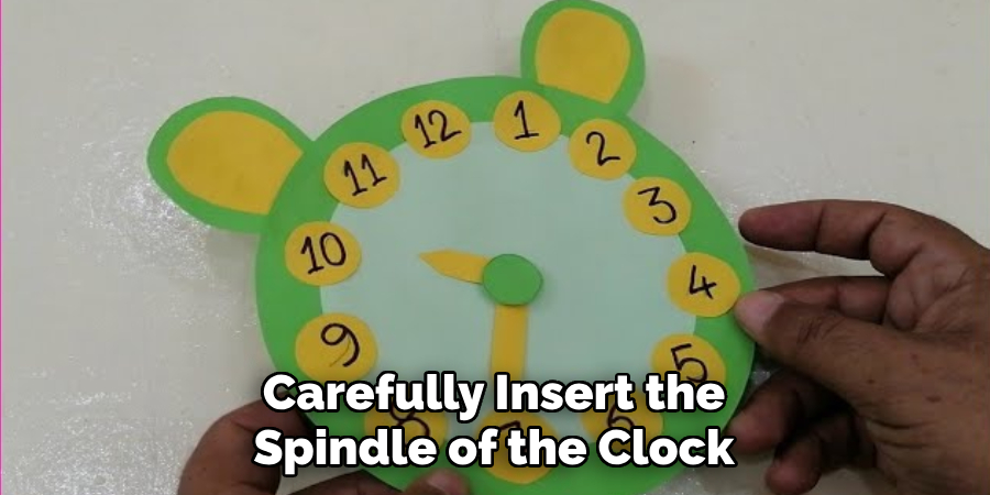 Carefully Insert the Spindle of the Clock