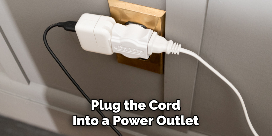 Plug the Cord Into a Power Outlet